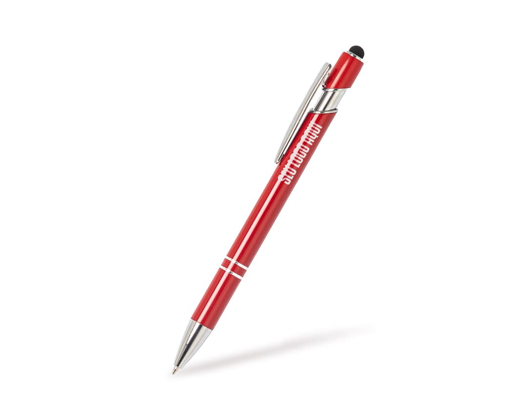 Caneta metal touch em diversas cores sobre uma mesa de escritório, ao lado de um bloco de notas, lápis e papel.