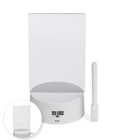 Luminária Led de Mesa na cor preta, com hastes flexíveis e base redonda. Acesa, iluminando um ambiente com luz branca.